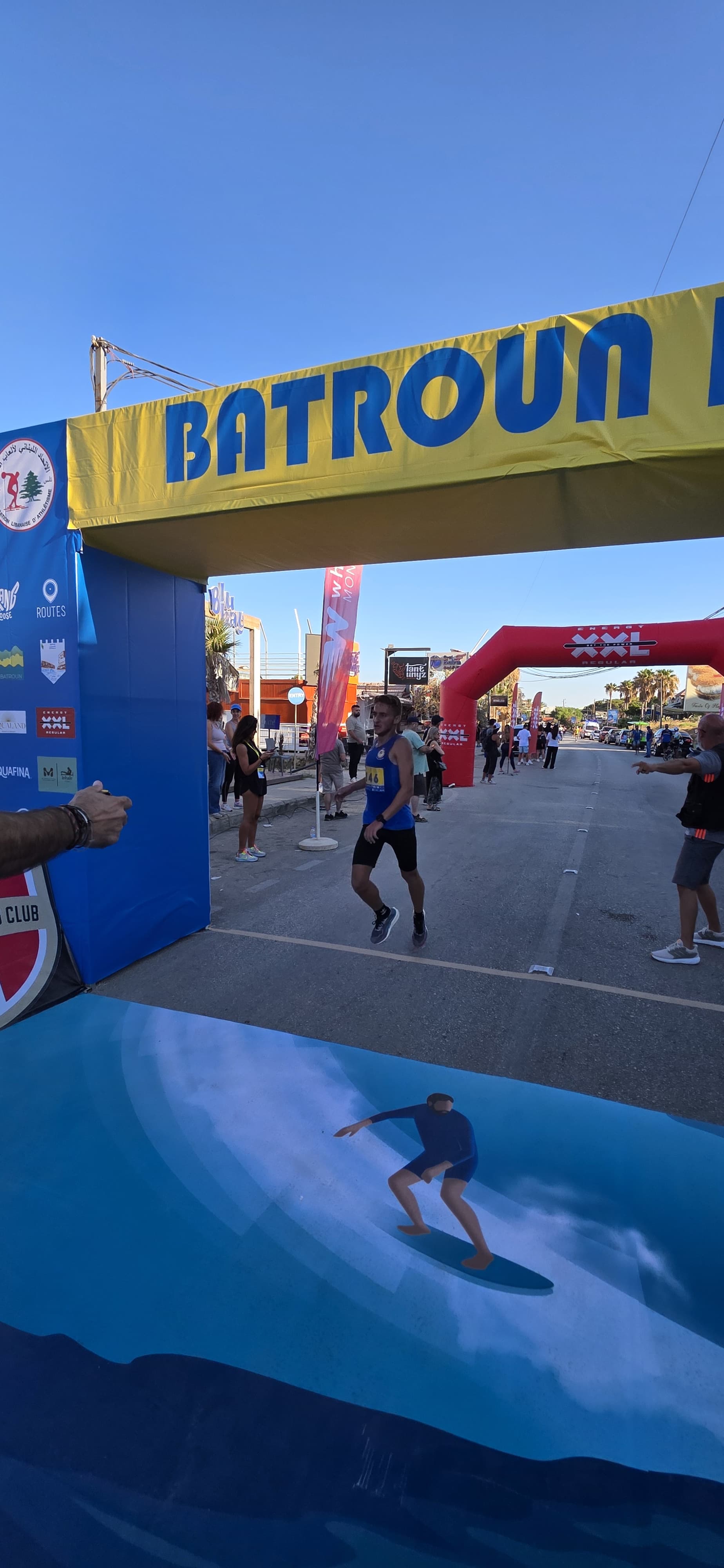Runners crossing the Batroun Race finish line